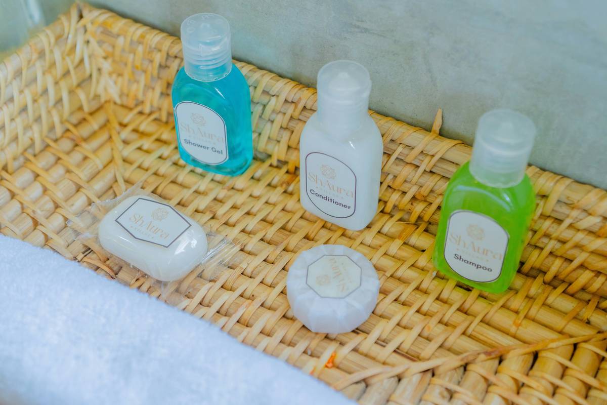 Woman gently lathering skincare product shower gel wash bath on damp skin in a steamy bathroom